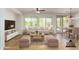 Bright living room with large windows, neutral furniture, and tile flooring at 4548 E Carob Dr, Gilbert, AZ 85298