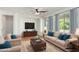 Inviting living room with comfortable seating, wood floors, and ample natural light at 4548 E Carob Dr, Gilbert, AZ 85298