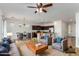 Open-concept living space with modern furniture, a kitchen island, and tile flooring at 4548 E Carob Dr, Gilbert, AZ 85298