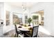 Dining area with a round table, comfortable chairs, and natural light from large windows offering a view of the outdoors at 8132 W Hatfield Rd, Peoria, AZ 85383