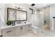 Bright bathroom with a tiled shower, toilet, and a vanity with black hardware at 9989 E Aleka Way # 337, Scottsdale, AZ 85262