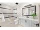 White bathroom features a tiled shower, toilet, and a white vanity with black hardware at 9989 E Aleka Way # 337, Scottsdale, AZ 85262