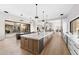 Open-concept kitchen featuring a large island, modern appliances, and a seamless connection to the living area at 9989 E Aleka Way # 337, Scottsdale, AZ 85262