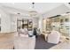 Inviting living room area with plush seating, stylish lighting, wine storage, and access to outdoor area at 9989 E Aleka Way # 337, Scottsdale, AZ 85262