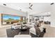 Open-concept living space with a fireplace, large windows, and seamless access to a modern kitchen at 9989 E Aleka Way # 337, Scottsdale, AZ 85262