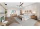 This bright main bedroom is furnished with a ceiling fan, king bed, and decor at 9989 E Aleka Way # 337, Scottsdale, AZ 85262