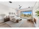 Spacious bedroom features a patio slider, hardwood floors, and a view of the natural desert landscape at 9989 E Aleka Way # 337, Scottsdale, AZ 85262