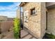 An outdoor shower featuring decorative stone, a black metal enclosure, and desert landscaping at 9989 E Aleka Way # 337, Scottsdale, AZ 85262