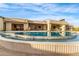 Resort-style pool with desert landscaping and views of an expansive luxury home at 9989 E Aleka Way # 337, Scottsdale, AZ 85262
