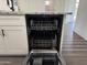 Open stainless steel dishwasher with interior racks and modern features, next to white kitchen cabinets at 1173 E Cordova Ave, Casa Grande, AZ 85122