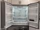 Modern stainless steel refrigerator with open doors revealing spacious and well-lit interior shelves at 1173 E Cordova Ave, Casa Grande, AZ 85122