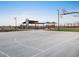 Outdoor basketball court with playground in background at 37034 W La Paz St, Maricopa, AZ 85138