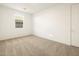 Bright bedroom with neutral carpet and large window at 37034 W La Paz St, Maricopa, AZ 85138