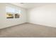 Well-lit bedroom featuring carpeted floors and a window at 37034 W La Paz St, Maricopa, AZ 85138