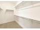 Spacious walk-in closet with ample shelving and hanging rods at 37034 W La Paz St, Maricopa, AZ 85138