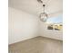 Bright dining room featuring a modern chandelier and wood-look tile floors at 37034 W La Paz St, Maricopa, AZ 85138