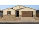 House exterior features a brown garage door and stone landscaping at 37034 W La Paz St, Maricopa, AZ 85138