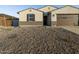 Landscaped front yard with gravel and small plants at 37034 W La Paz St, Maricopa, AZ 85138