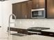 Sleek kitchen details, including a modern faucet and hexagonal tile backsplash at 37034 W La Paz St, Maricopa, AZ 85138