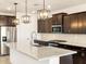 Modern kitchen featuring granite countertops and dark cabinetry at 37034 W La Paz St, Maricopa, AZ 85138