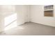 Sunlit bedroom with window, door, and neutral walls at 4314 W Josephine St, San Tan Valley, AZ 85144