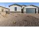 One-story home with gray exterior, dark garage door, and stone accents at 4314 W Josephine St, San Tan Valley, AZ 85144