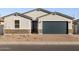 New construction home with gray exterior, dark garage door, and stone accents at 4314 W Josephine St, San Tan Valley, AZ 85144