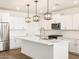 Bright kitchen featuring white cabinets, an island, and pendant lighting at 4314 W Josephine St, San Tan Valley, AZ 85144