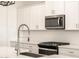 Stainless steel appliances and white shaker cabinets in this kitchen at 4314 W Josephine St, San Tan Valley, AZ 85144