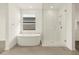 Bathroom featuring glass shower, free standing tub, tile flooring and natural light at 4937 W Hunter Trl, San Tan Valley, AZ 85144