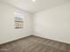 Bright bedroom featuring neutral carpet, white walls, and a window allowing natural light at 4937 W Hunter Trl, San Tan Valley, AZ 85144