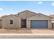 Charming single-story home featuring a blue garage door, a modern gray exterior and low-maintenance desert landscaping at 4937 W Hunter Trl, San Tan Valley, AZ 85144