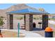 Outdoor picnic area with stone pillars, a blue roof, a grill, trashcan and seating for residents at 4937 W Hunter Trl, San Tan Valley, AZ 85144