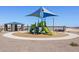 Community playground with colorful play structure and seating surrounded by desert landscape at 4937 W Hunter Trl, San Tan Valley, AZ 85144