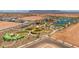 Aerial view of community with playground, lake, and surrounding landscape at 1206 W J Waltz Way, Apache Junction, AZ 85120