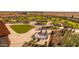 Aerial view of a community park with a playground, grassy areas, and a large chessboard at 1206 W J Waltz Way, Apache Junction, AZ 85120