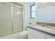 Bright bathroom featuring a walk-in shower, modern vanity, and ample natural light at 12442 W Marble Dr, Sun City West, AZ 85375