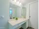 Bathroom featuring a large mirror, vanity with sink, and ample lighting at 12442 W Marble Dr, Sun City West, AZ 85375