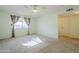 Sunny bedroom with carpet flooring and a window with curtains at 12442 W Marble Dr, Sun City West, AZ 85375