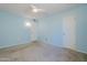 Spacious bedroom with blue walls, carpeted floor and 2 closets at 12442 W Marble Dr, Sun City West, AZ 85375