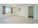 Bright bedroom has neutral tile floors, art, and a large window with views at 12442 W Marble Dr, Sun City West, AZ 85375