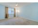 Light blue bedroom with a window and neutral carpeting at 12442 W Marble Dr, Sun City West, AZ 85375