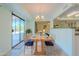 An airy dining room features outdoor access and adjoins both the kitchen and an additional seating area at 12442 W Marble Dr, Sun City West, AZ 85375