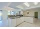 Open kitchen with a mosaic backsplash and modern appliances at 12442 W Marble Dr, Sun City West, AZ 85375