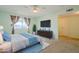 Relaxing main bedroom with soft carpet, large window, ceiling fan, and en-suite bathroom at 12442 W Marble Dr, Sun City West, AZ 85375