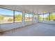 Enclosed sunroom with bright windows offers panoramic views of the surrounding landscape at 12442 W Marble Dr, Sun City West, AZ 85375