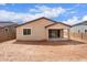 Backyard view showing a covered patio, block fence, and minimal landscaping at 18650 E Panchito Dr, Gold Canyon, AZ 85118