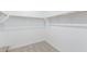 Walk in closet with carpet flooring and wood shelving rods at 18650 E Panchito Dr, Gold Canyon, AZ 85118