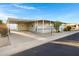 Exterior view of a home with a covered carport, front porch, desert landscaping, and neighborhood street at 2233 E Behrend Dr # 132, Phoenix, AZ 85024