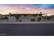 Exterior view of a home with desert landscaping and a large front porch, under a colorful twilight sky at 2233 E Behrend Dr # 132, Phoenix, AZ 85024